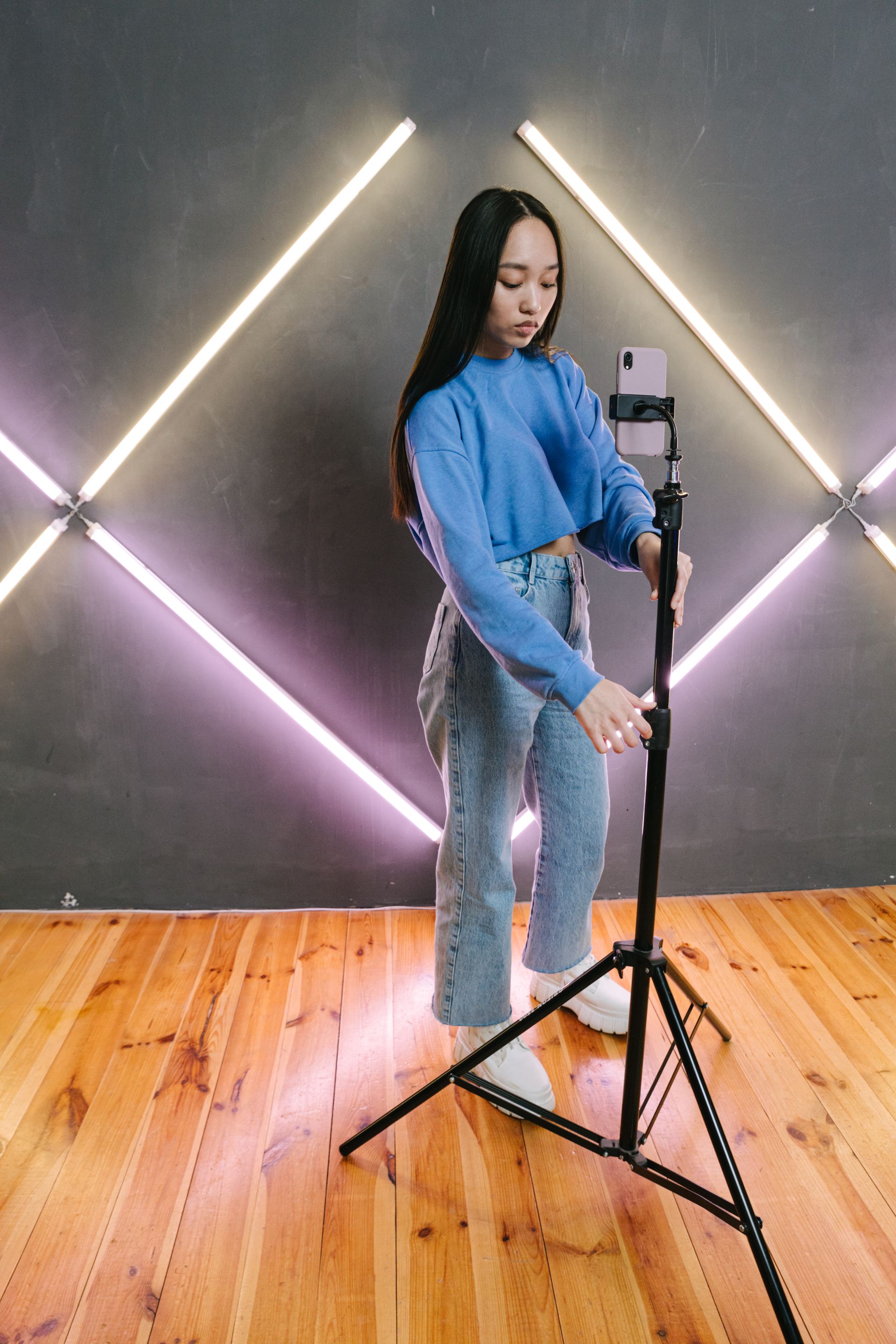 Creator producing social content with a smartphone in a studio